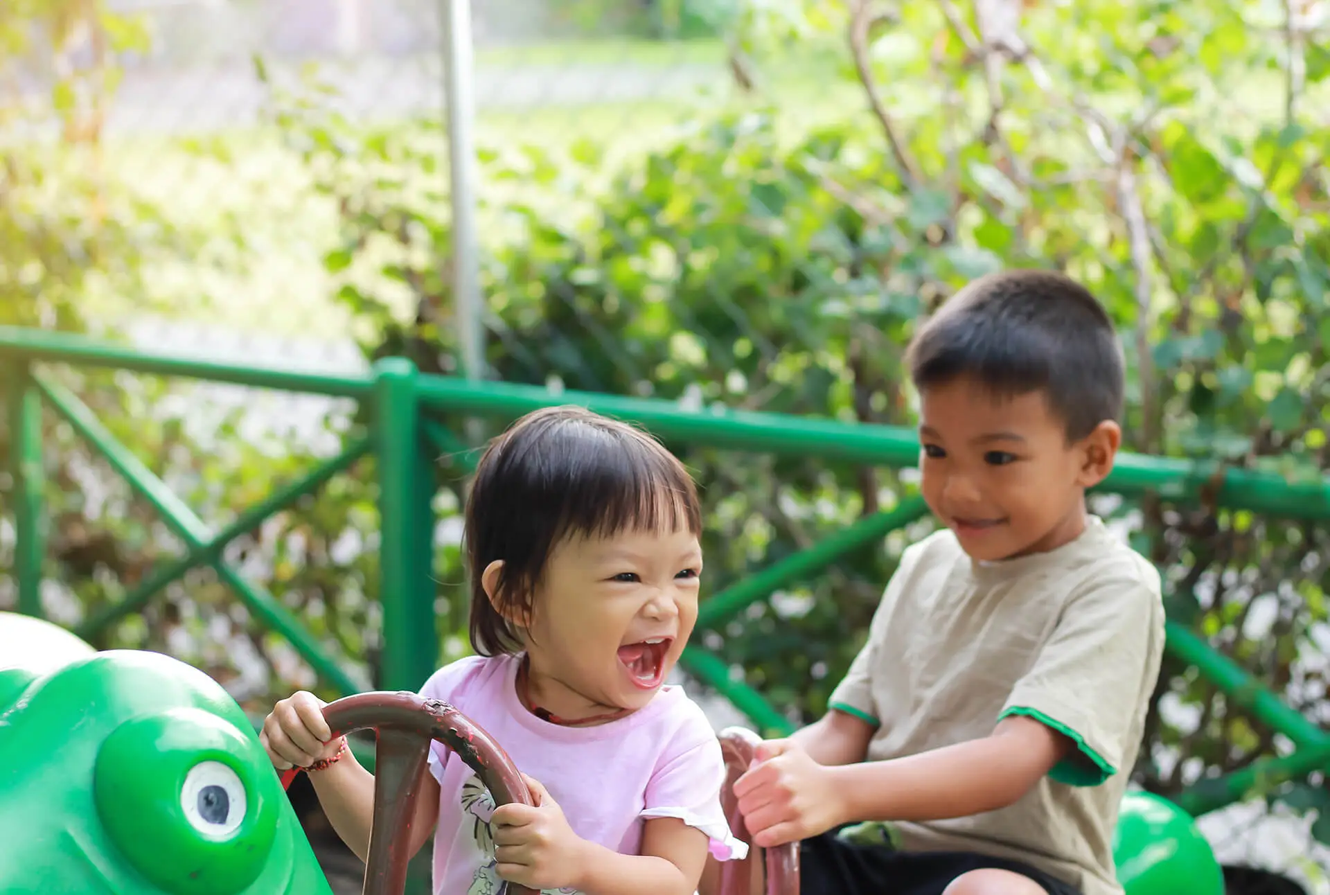 Happy asian siblings children laughing and smiling